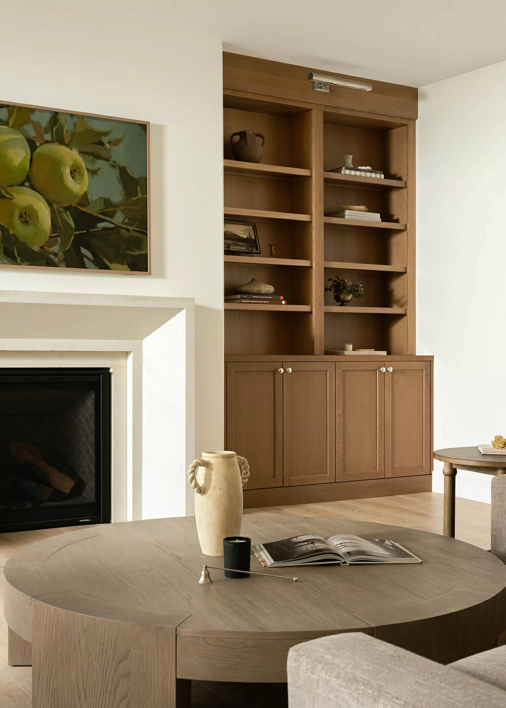 The cabinet and bookcase built-ins around the fireplace in this living room design feature a light to medium stained finish on Quartersawn Oak wood.
