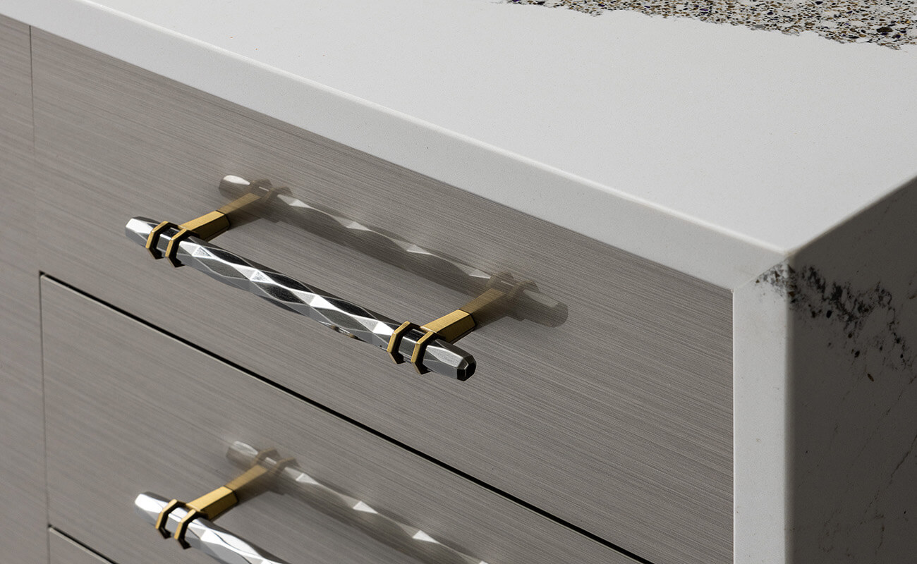 A close look at glossy slab cabinet door with a metalic like detail in a modern kitchen design.