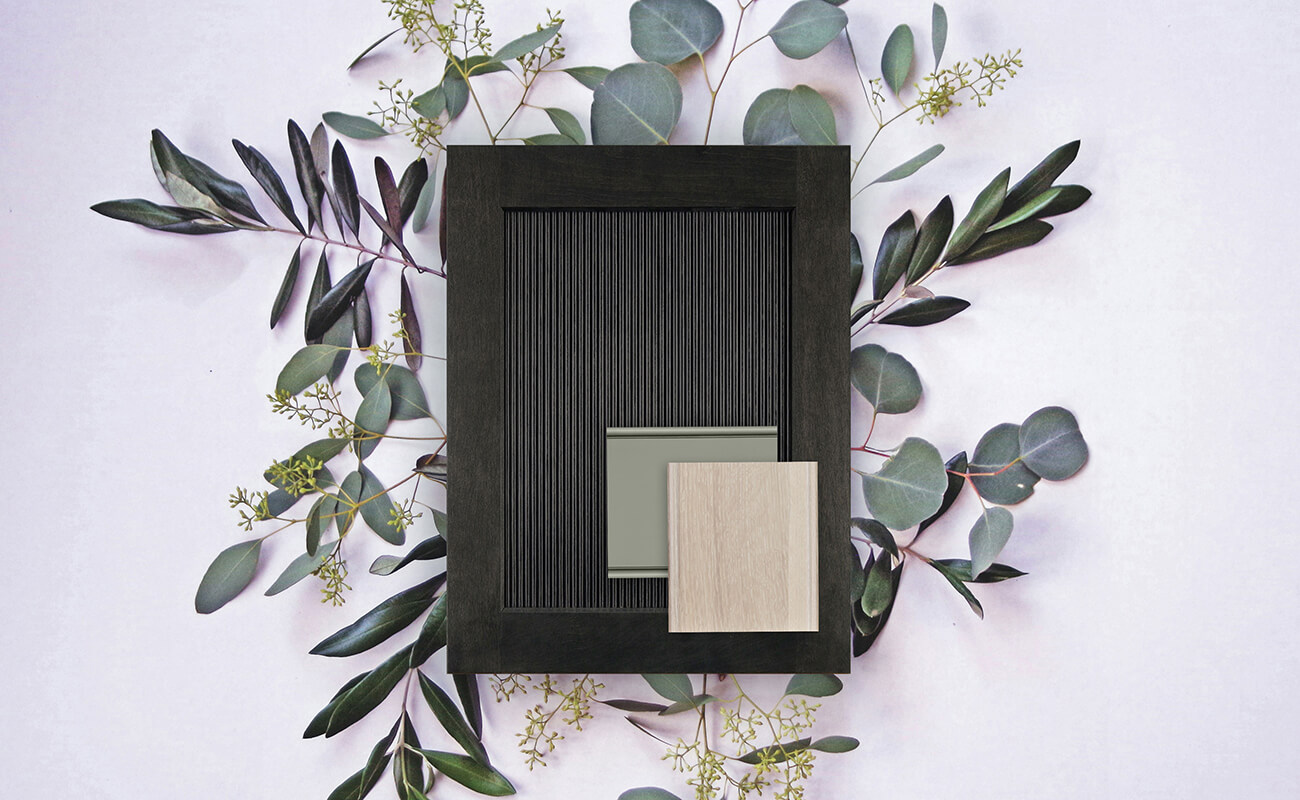 A dark stained reeded cabinet door style with samples of a light green paint color and light stained and cerused/limed sample of Quarter-Sawn White Oak.