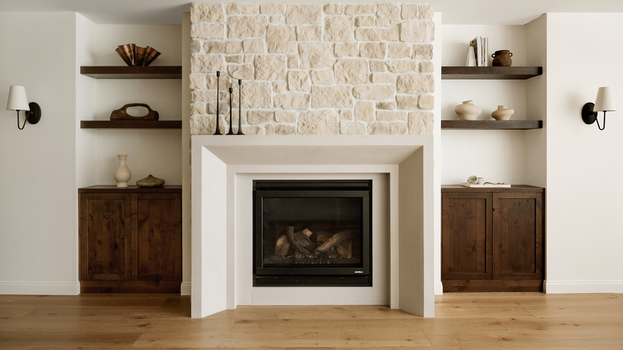 A transitional styled livingroom fireplace wall with built-in knotty alder cabinets that's full of raw, natural textures and hues.